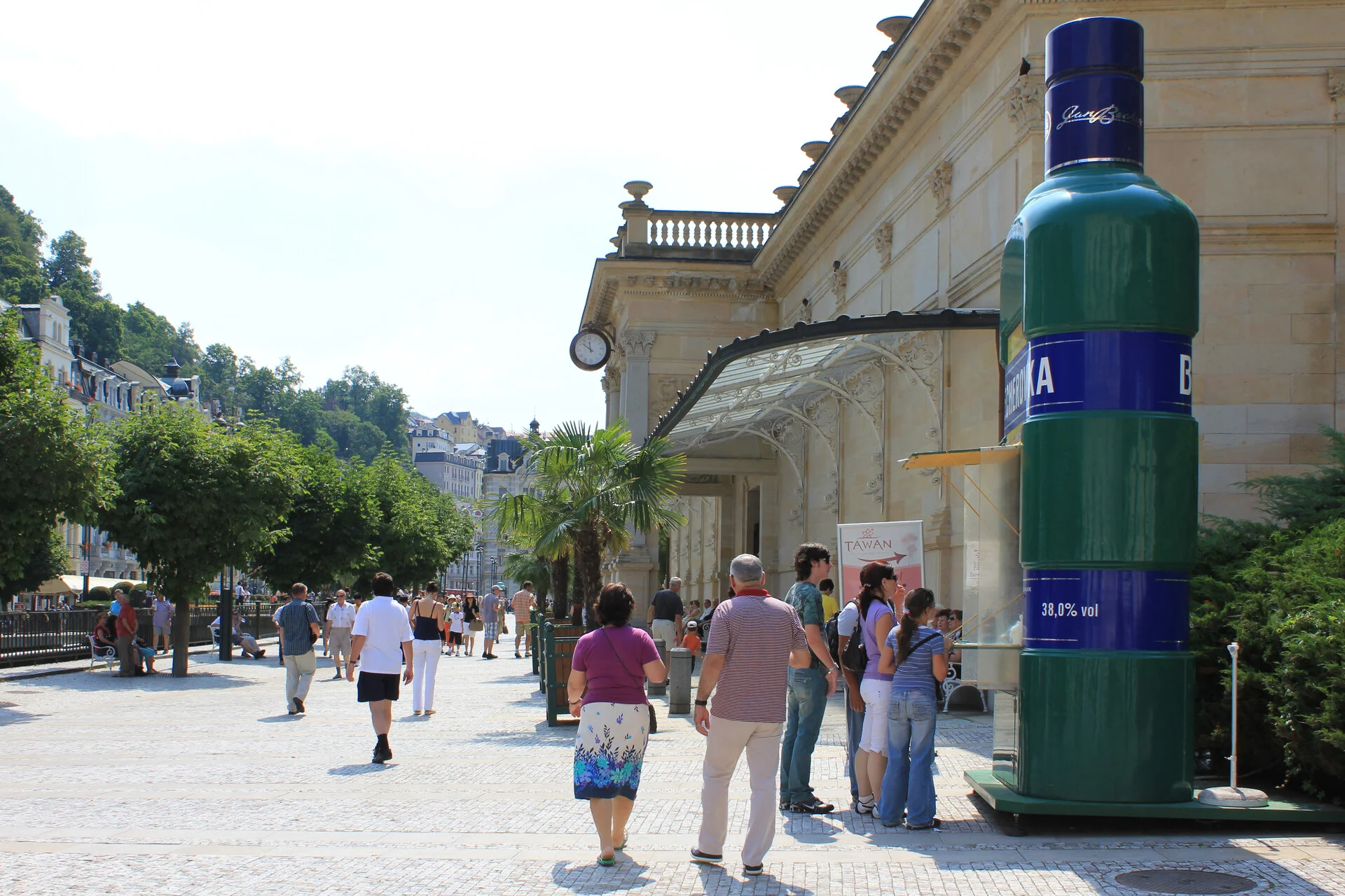 Karlovy Vary Mill Colonnade and thermal springs along the Teplá river with pastel buildings stacked above
