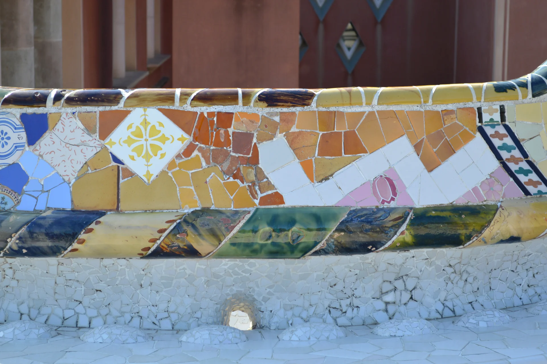 Colorful mosaic tilework on the serpentine bench at Park Güell in Barcelona