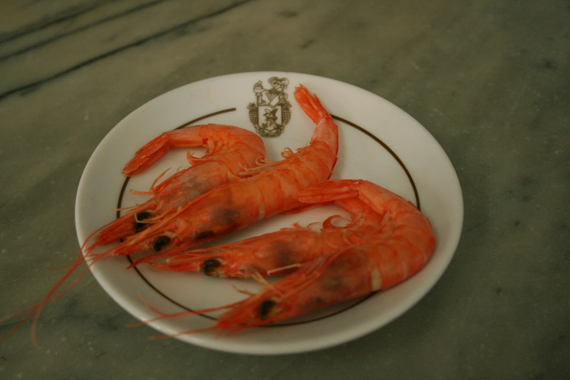 A plate of Spanish tapas with grilled langostino prawns in Barcelona