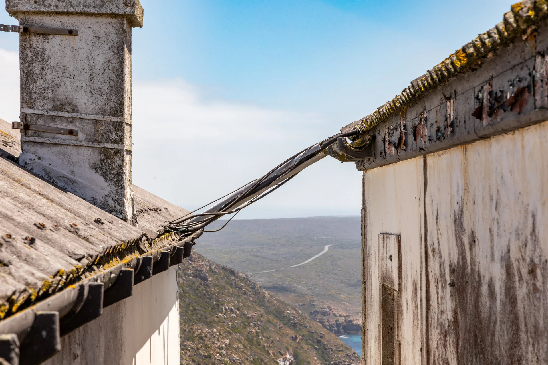 Cape Point lighthouse perched on dramatic cliffs above the crashing Atlantic Ocean in South Africa