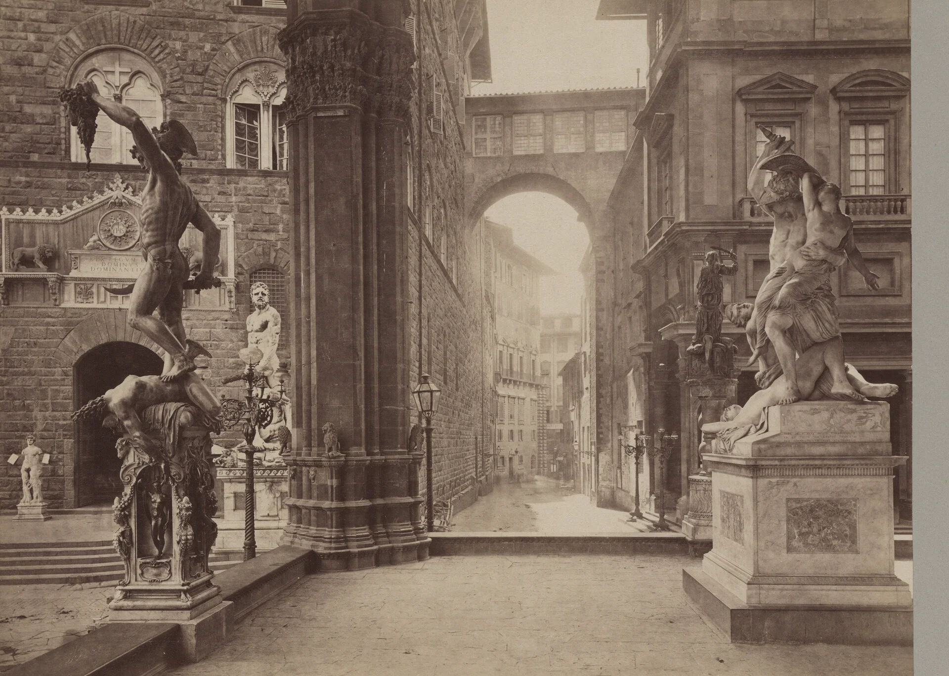 The Loggia dei Lanzi open-air sculpture gallery in Piazza della Signoria, with Cellini's bronze Perseus, in a historic photograph of Florence