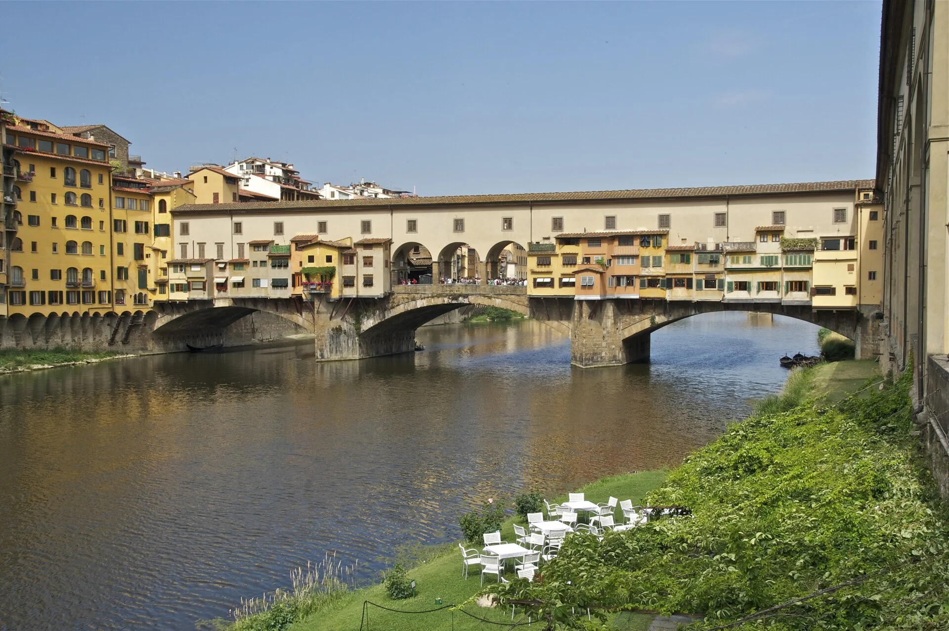 The Ponte Vecchio bridge lined with medieval shops spanning the Arno River in Florence