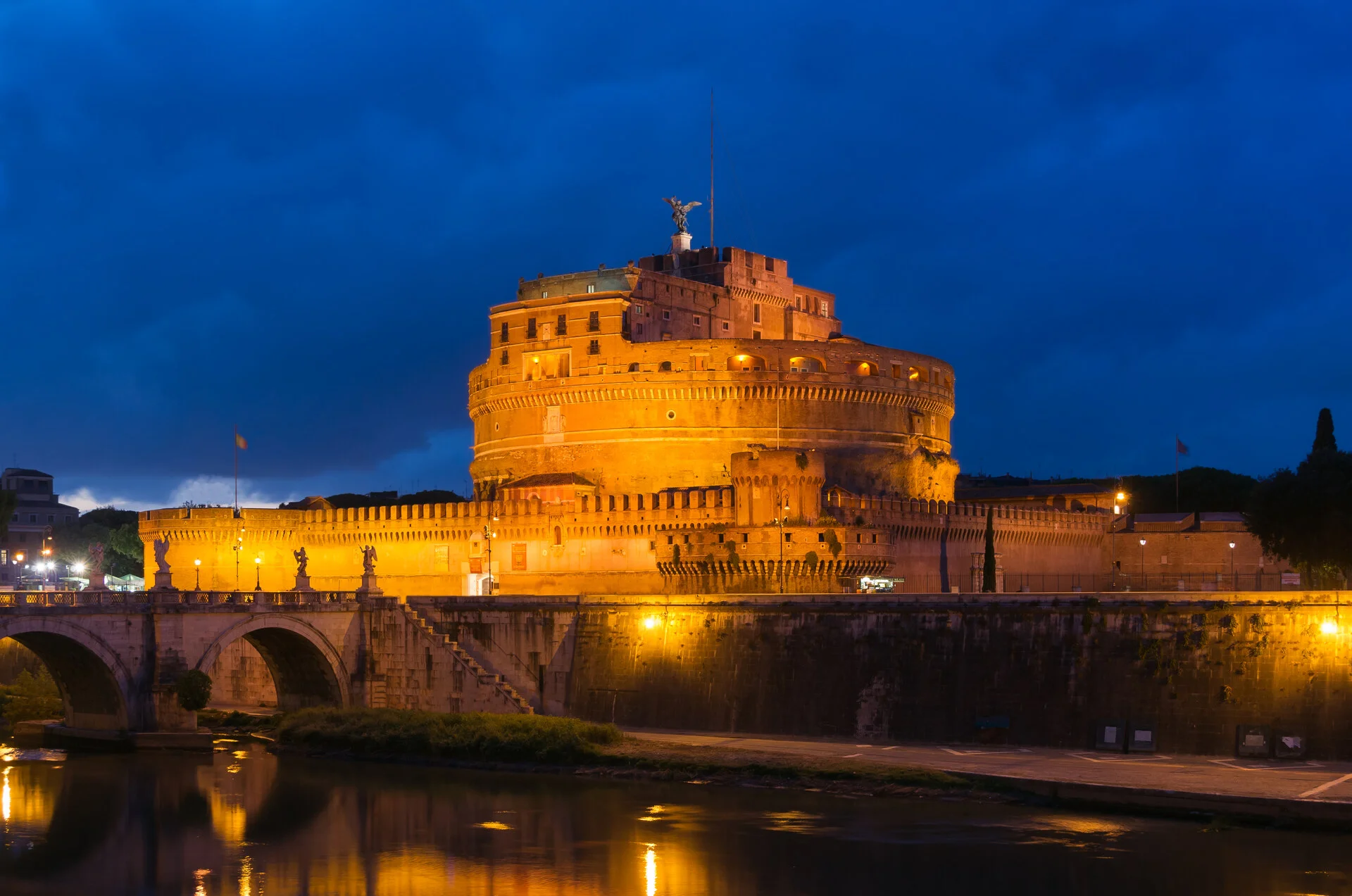 Castel Sant'Angelo and its bridge over the Tiber River at dusk in Rome