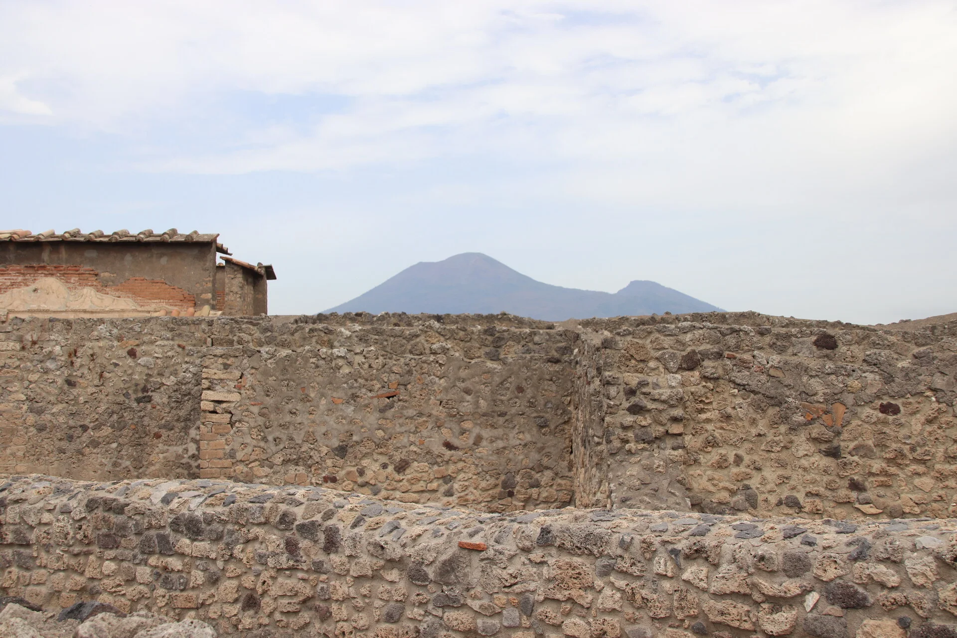 The ruins of Pompeii with Mount Vesuvius rising in the background near Naples