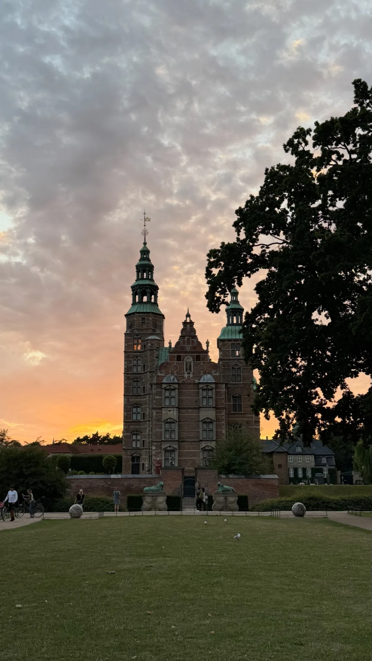 Rosenborg Castle in Copenhagen silhouetted against a pink summer sunset from the King's Garden