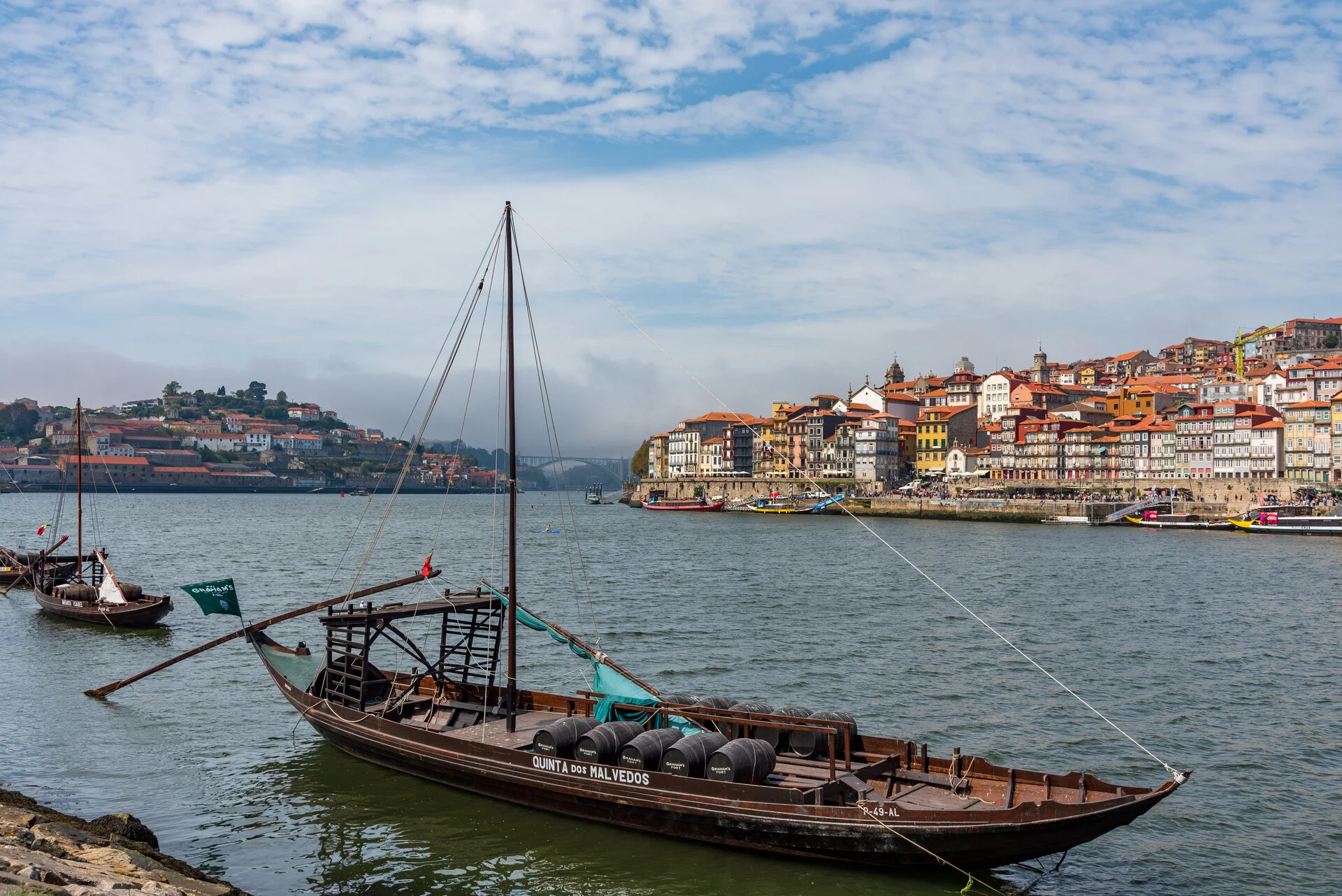A traditional wooden rabelo boat once used to carry Port wine, moored on the Douro River