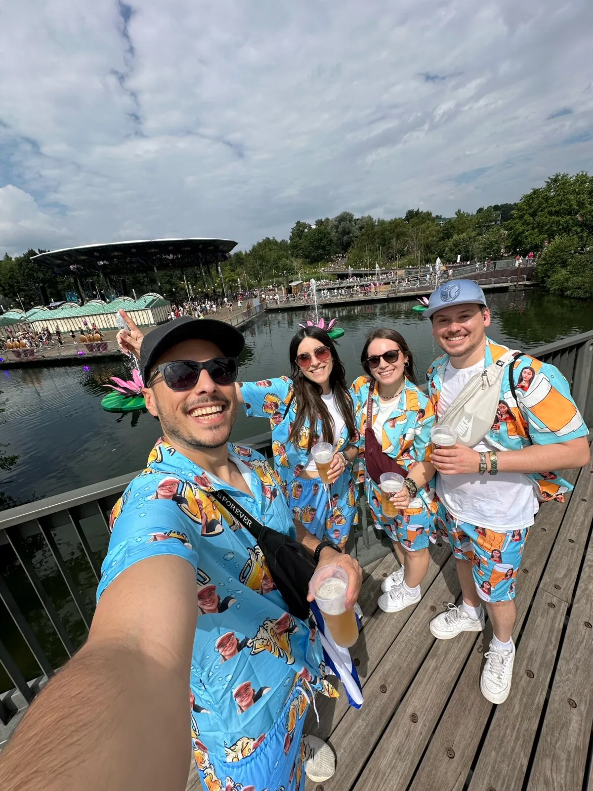 Our group at Tomorrowland 2025 wearing matching light blue shirts printed with beer mugs and photos of each other