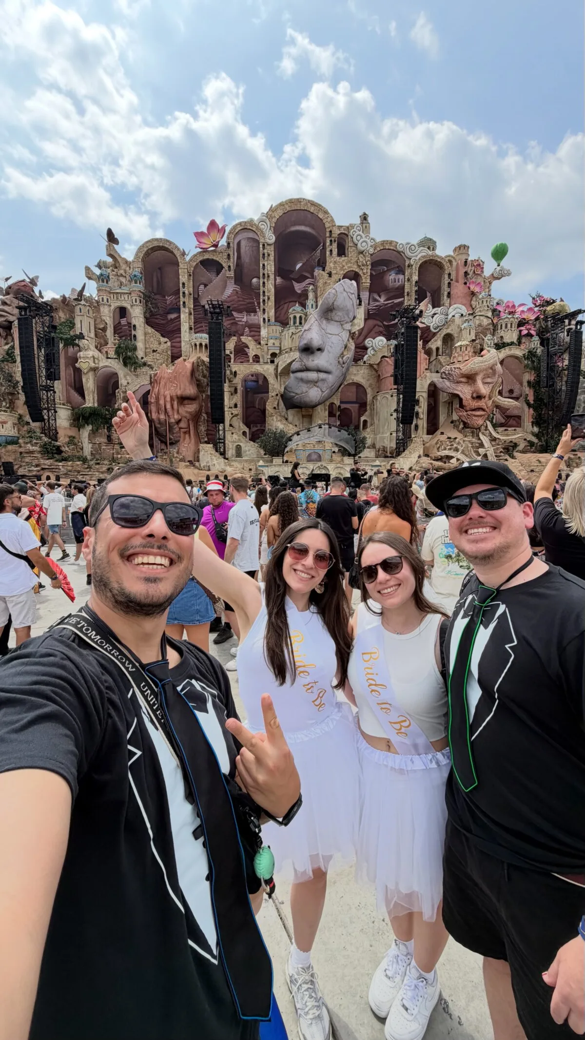 Friends in front of the huge sculpted Tomorrowland 2026 Mainstage in Boom, Belgium