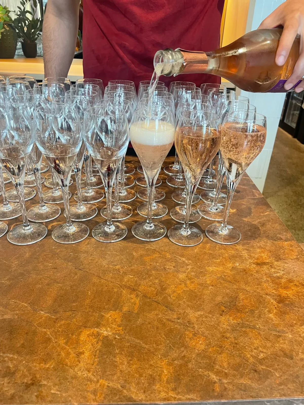 Glasses of Solo Vida sparkling cava being poured at the Belgian Classics Experience restaurant inside Tomorrowland
