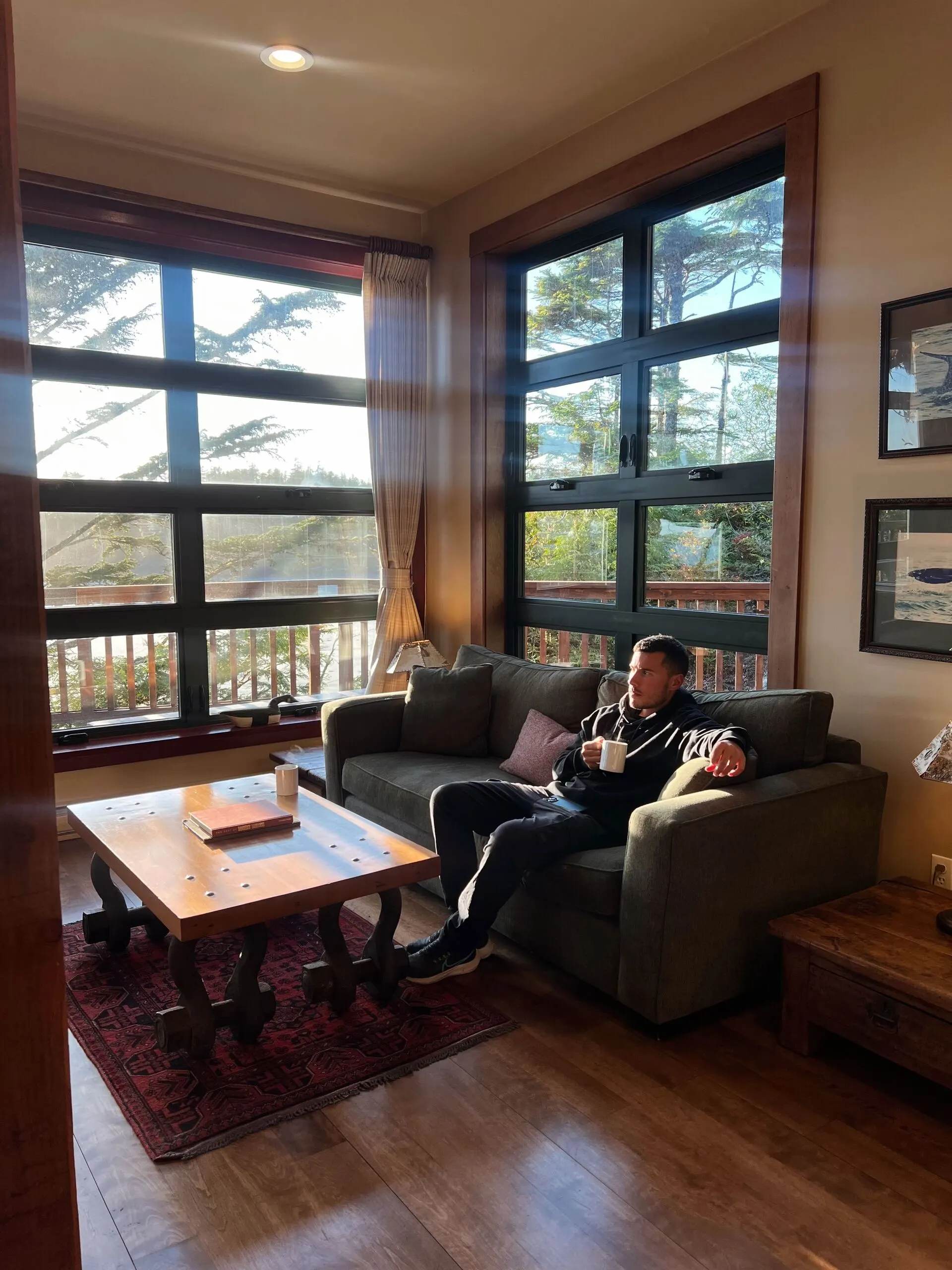 Cozy lounge area at Middle Beach Lodge with ocean views through large windows